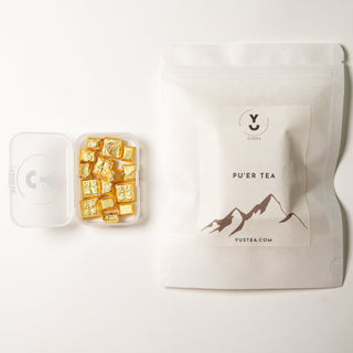 YUSTEA Pu'er tea packaging with gold tea resin cubes on a white background