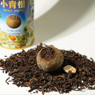 Orange Tea balls and leaves with a canister in the background