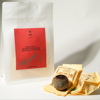 Tea package with a red label featuring mountain graphics on a white background